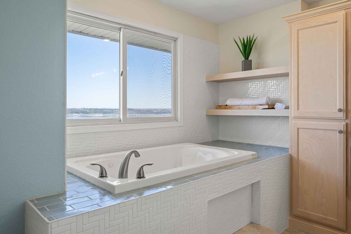 bathroom remodel with large white bath tub